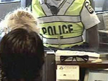 Lois Harvey didn't notice the "POLICE" behind her at the bank